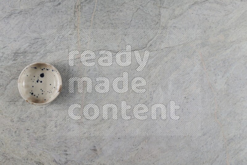 A multicolored pottery Bowl on grey marble background