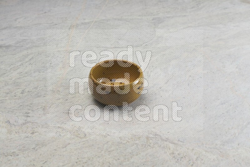 A multicolored pottery bowl on grey marble background