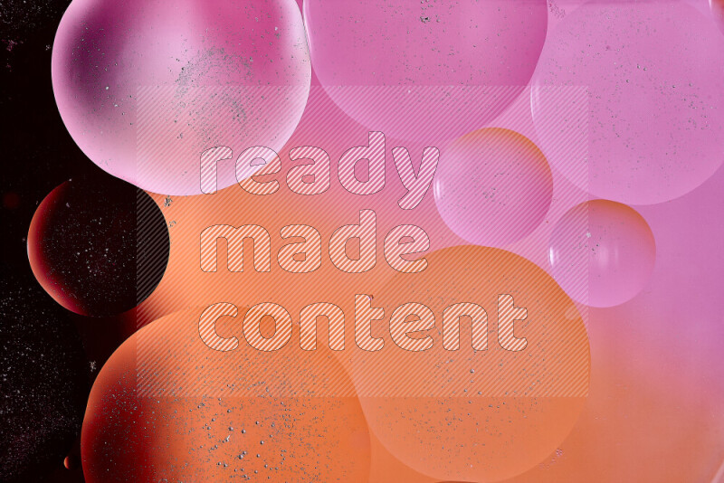 Close-ups of abstract oil bubbles on water surface in shades of red, orange and pink