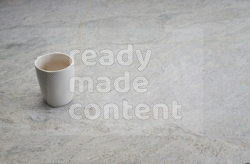 A white ceramic mug on grey marble background
