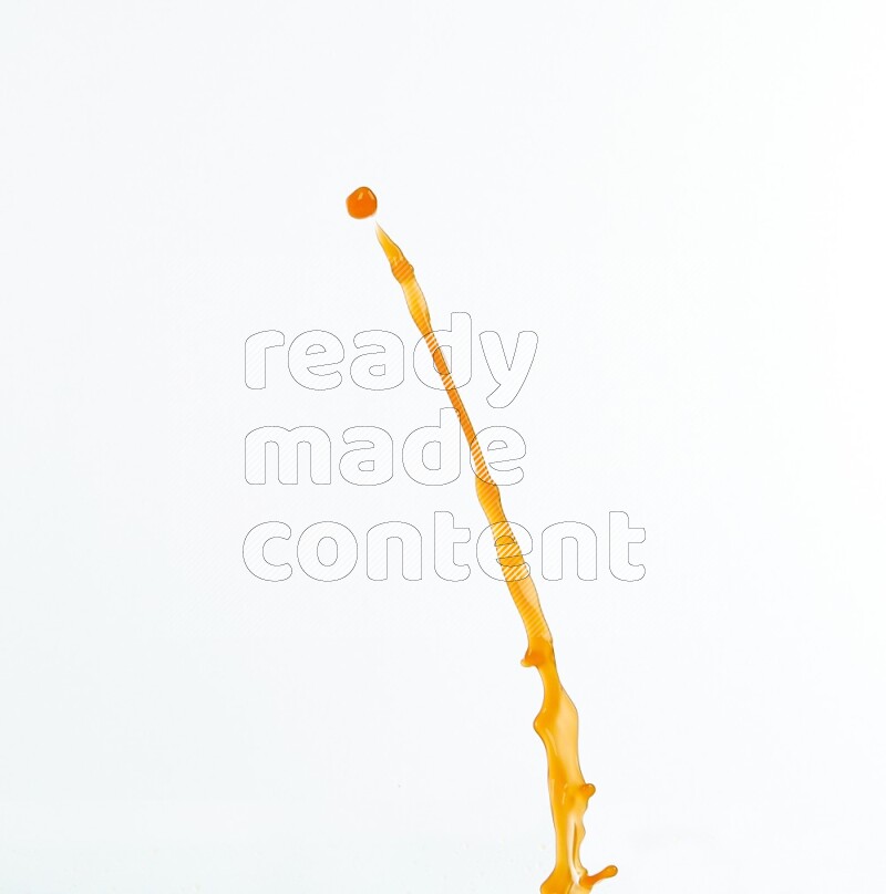 Orange liquid splash and drops on white background