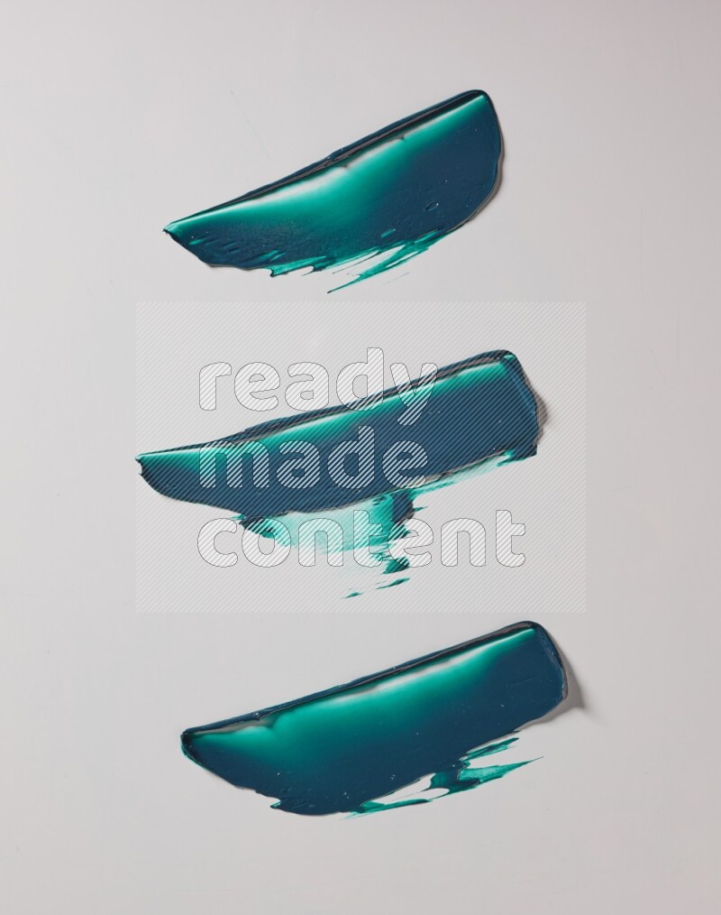 Turquoise painting knife strokes on white background