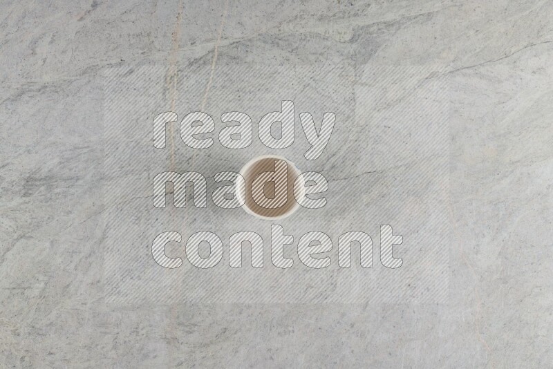 A multicolored pottery Cup on grey marble background