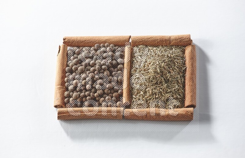 2 squares of cinnamon sticks full of allspice and cumin on white flooring