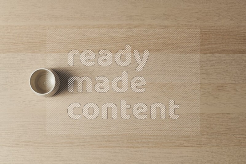 A white pottery bowl on light wooden background