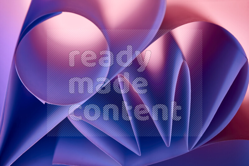 An artistic display of paper folds creating a harmonious blend of geometric shapes, highlighted by soft lighting in purple tones