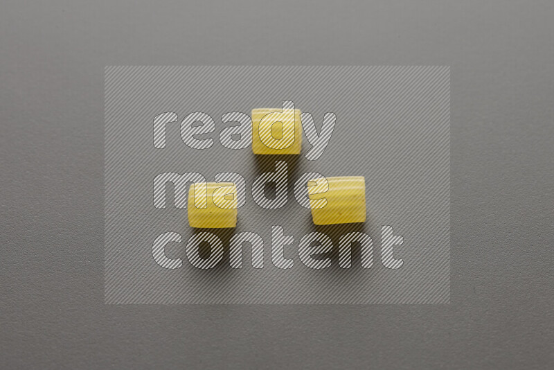 Small rings pasta on grey background