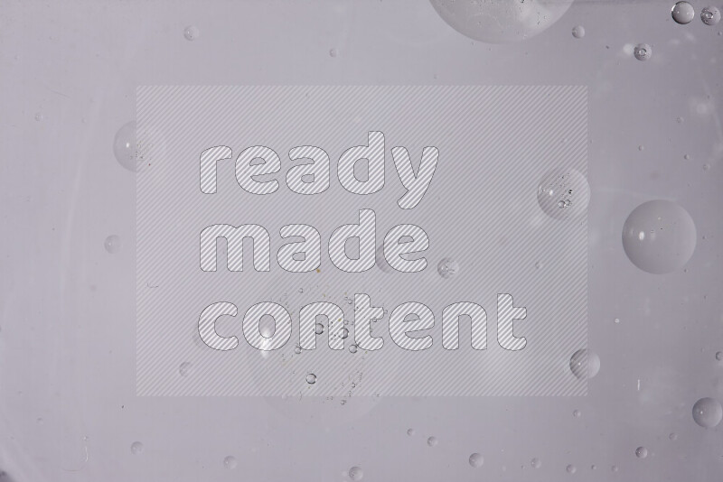 Abstract oil droplets in a water surface on white background