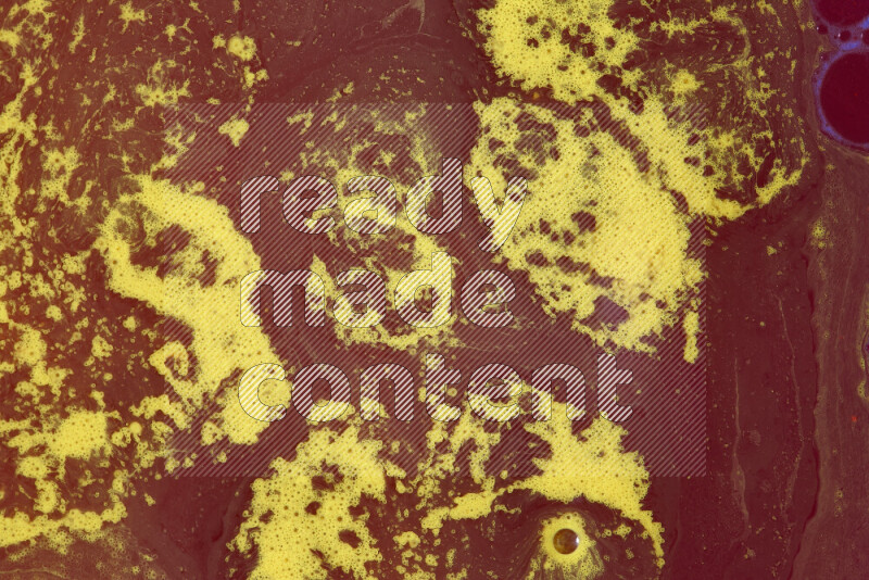 The image depicts a marbling effect with swirling patterns of red and yellow