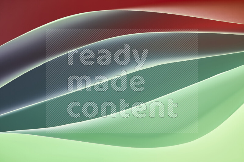 This image showcases an abstract paper art composition with paper curves in green and red gradients created by colored light