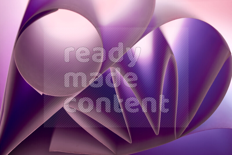 An artistic display of paper folds creating a harmonious blend of geometric shapes, highlighted by soft lighting in purple tones