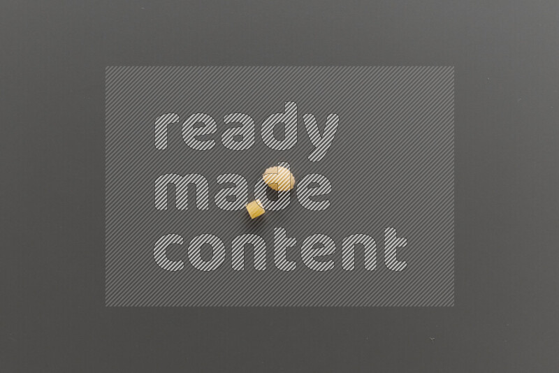 Small rings pasta with other types of pasta on grey background