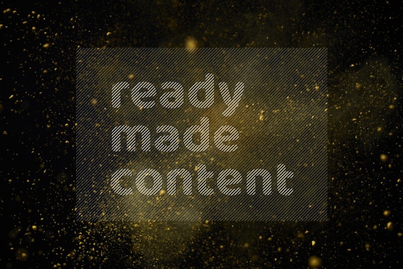 Yellow powder explosion on black background