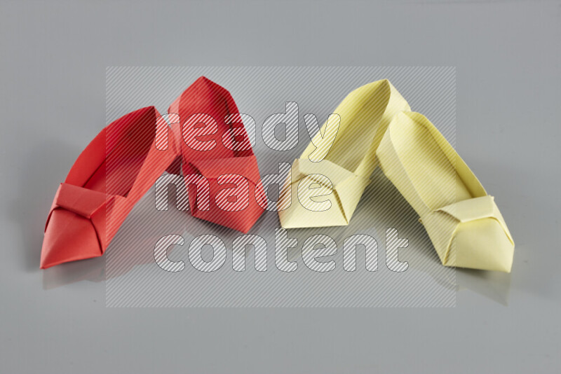 Origami shoes on grey background