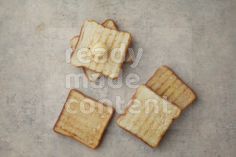 Toasted White Toast slices with a butter curl on a light blue textured background