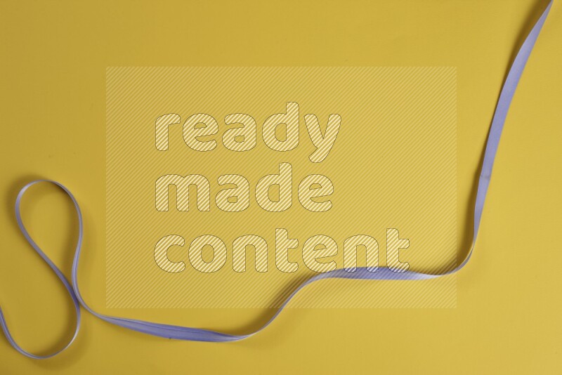 مجموعة من أدوات الخياطة والتفصيل إرجوانية اللون على خلفية صفراء