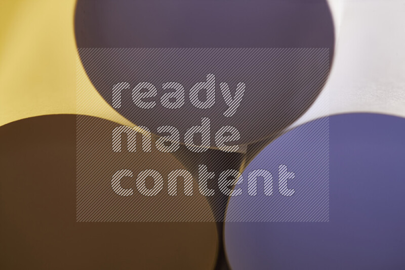 The image shows an abstract paper art with circular shapes in varying shades of grey and warm tones