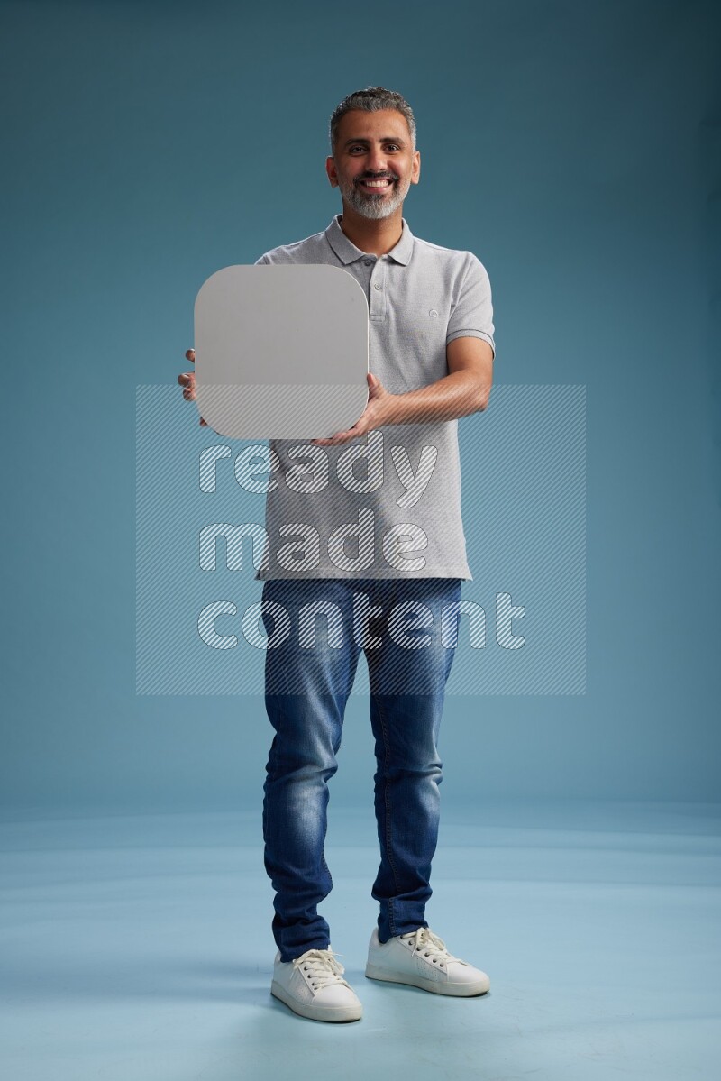 Man Standing holding social media sign on blue background