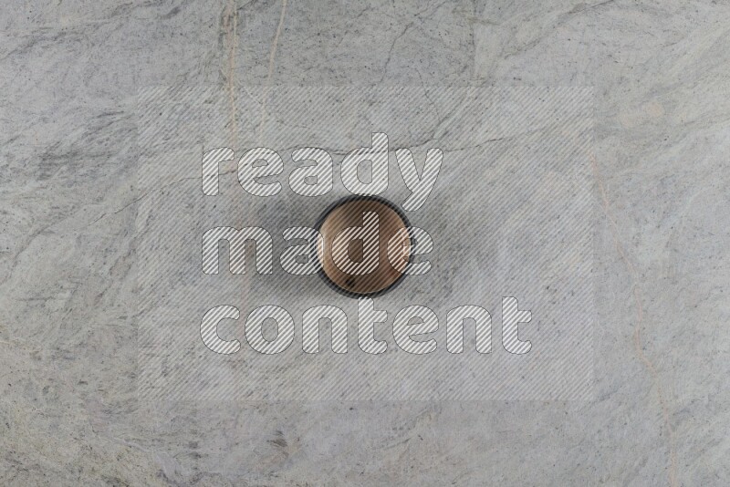 A multicolored pottery Bowl on grey marble background