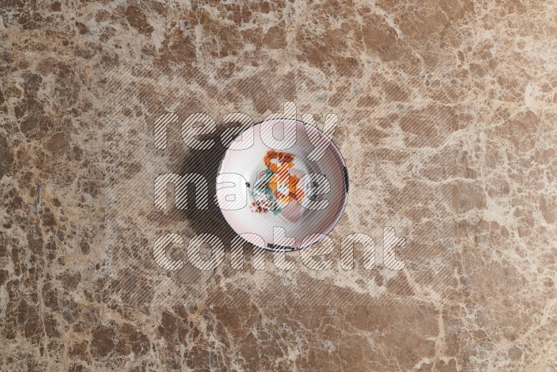 A vintage metal plate on beige marble background