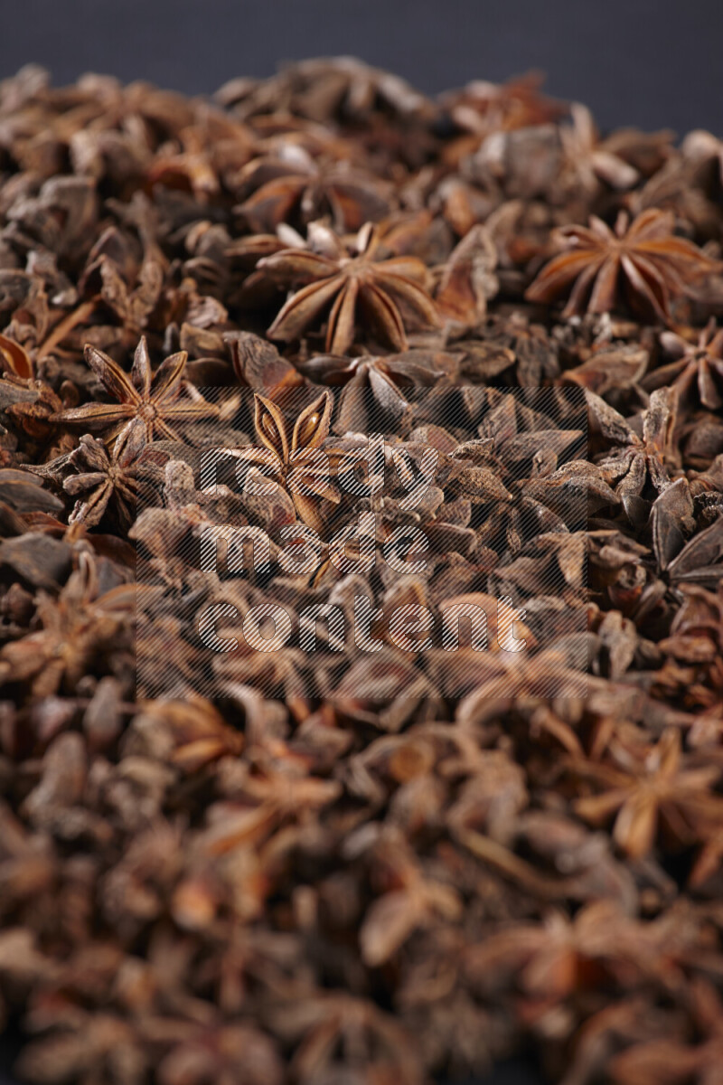 Star Anise fill the frame on black flooring