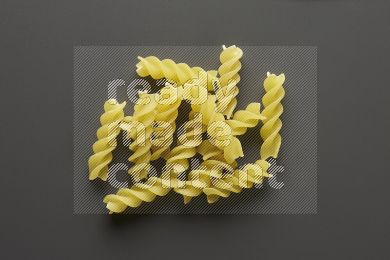Fusilli pasta on grey background