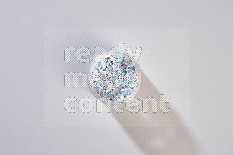 Colored buttons in a glass jar on grey background