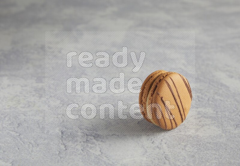 45º Shot of light brown  Almond Cream macaron on white  marble background
