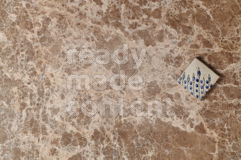 A decorative coaster on beige marble background