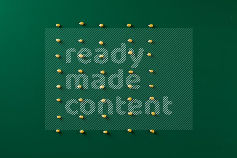 Popcorn seeds on a green background in a top view shot
