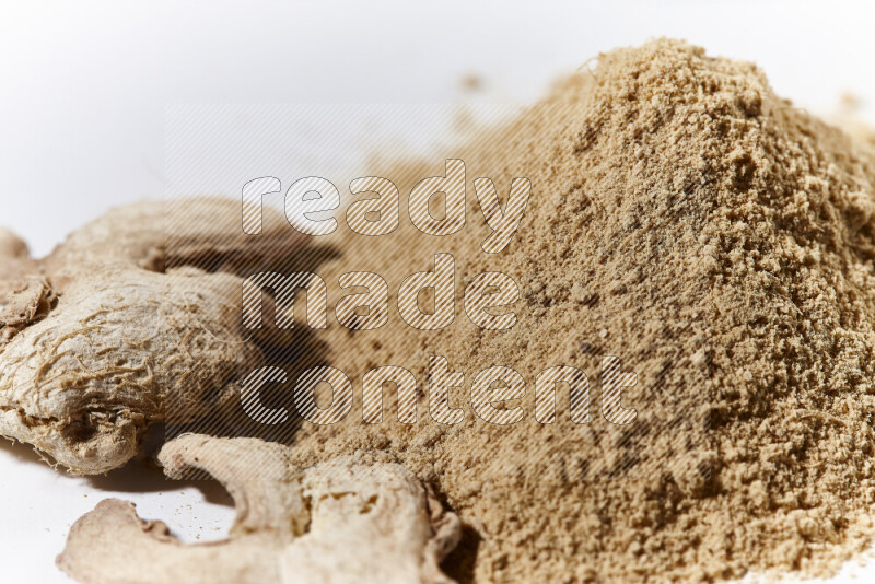 A bunch of ground ginger powder on white background