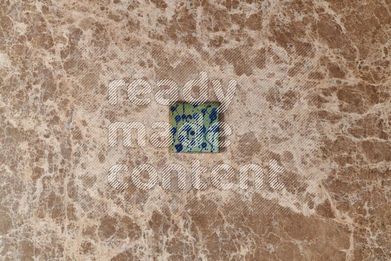 A decorative coaster on beige marble background