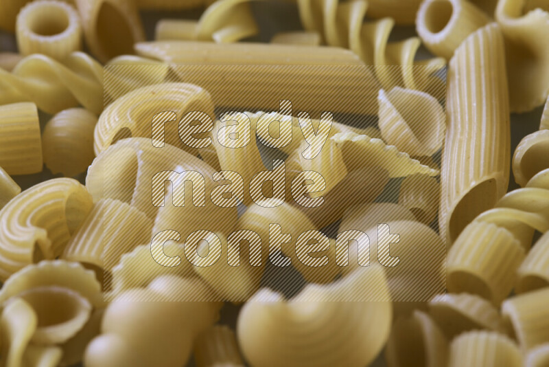 Different pasta types on light blue background