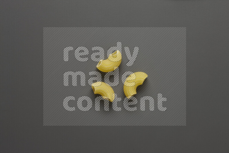 Elbow pasta on grey background