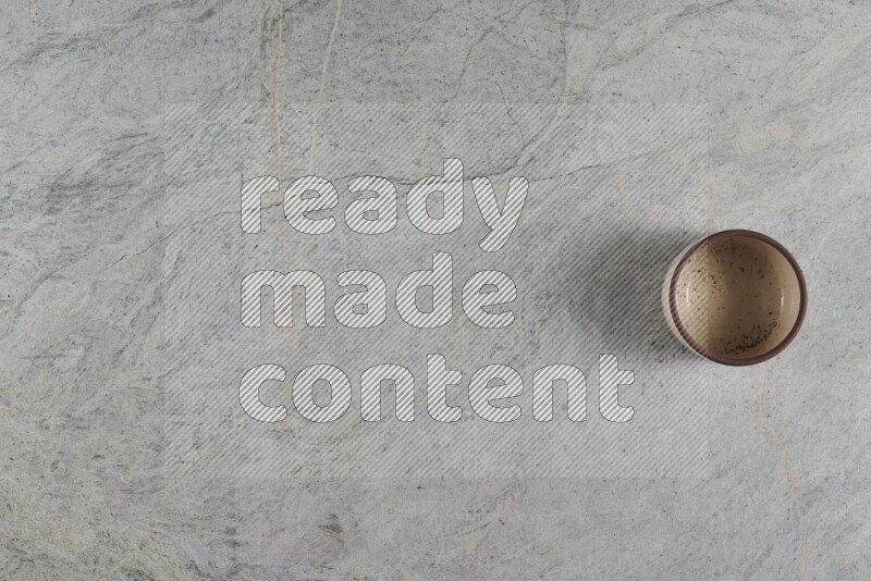 A multicolored pottery Bowl on grey marble background