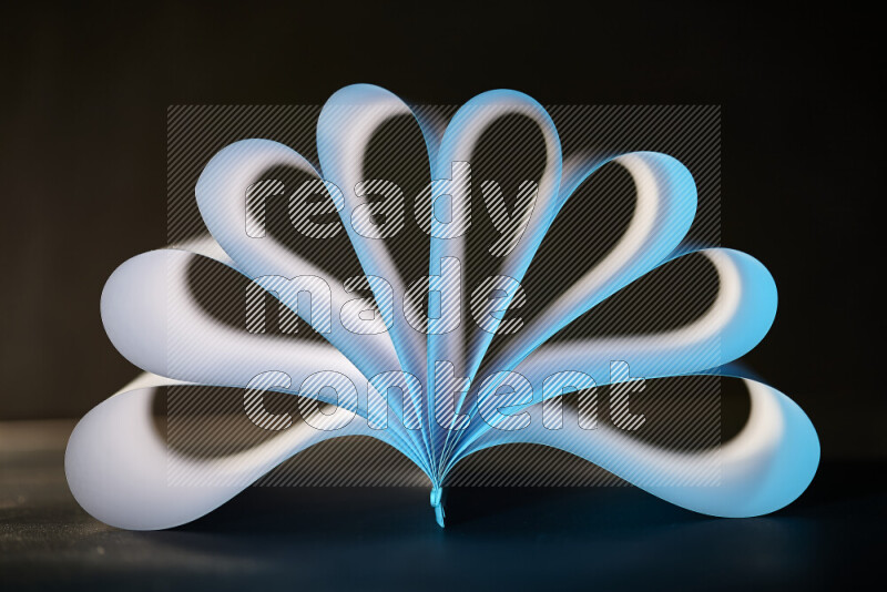 An abstract art piece displaying smooth curves in blue and white gradients created by colored light