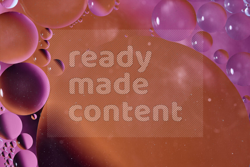 Close-ups of abstract oil bubbles on water surface in shades of orange and pink