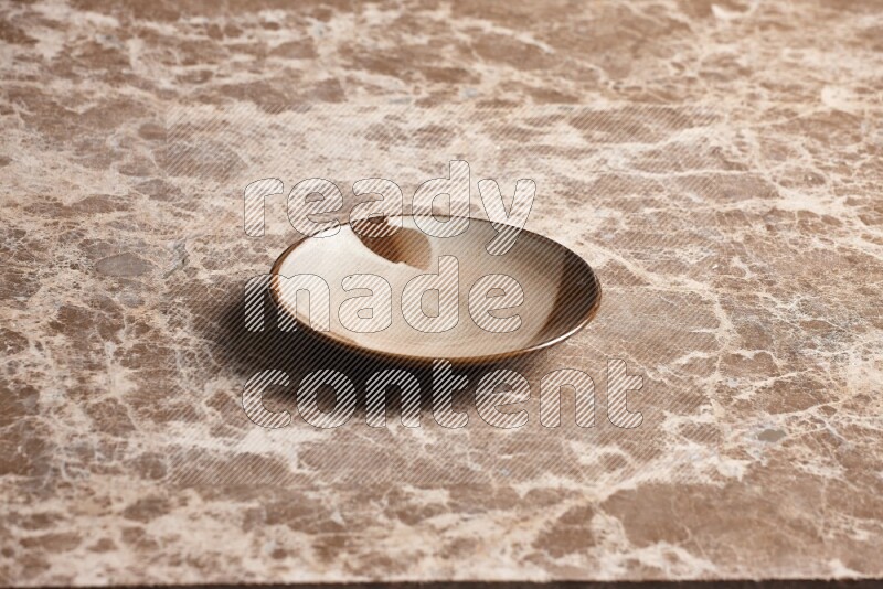 A multicolored pottery plate on beige marble background