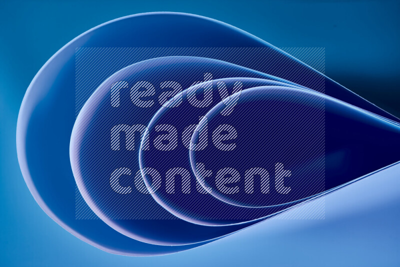 An abstract art of paper folded into smooth curves in blue gradients