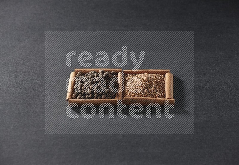 2 squares of cinnamon sticks full of mustard seeds and allspice on black flooring