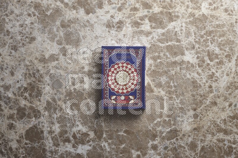 The holy Quran on beige marble background