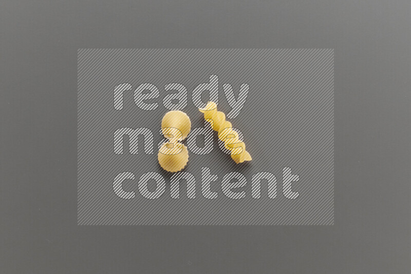 Fiocchi pasta with other types of pasta on grey background