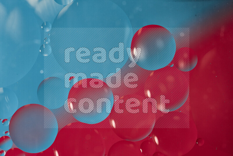 Close-ups of abstract oil bubbles on water surface in shades of blue and pink