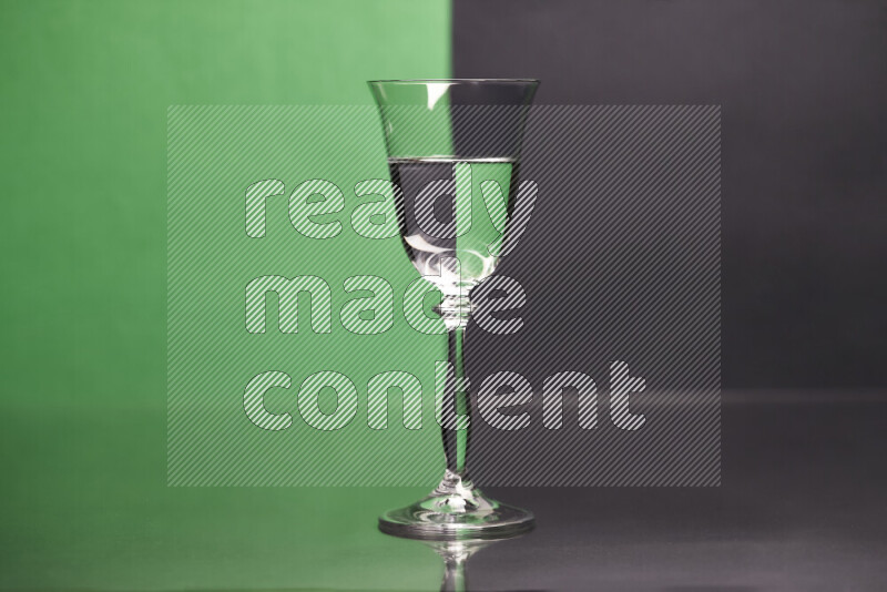The image features a clear glassware filled with water, set against green and black background