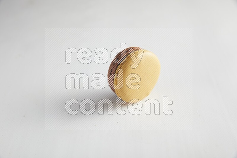 45º Shot of Yellow and Brown Chai Latte macaron on white background