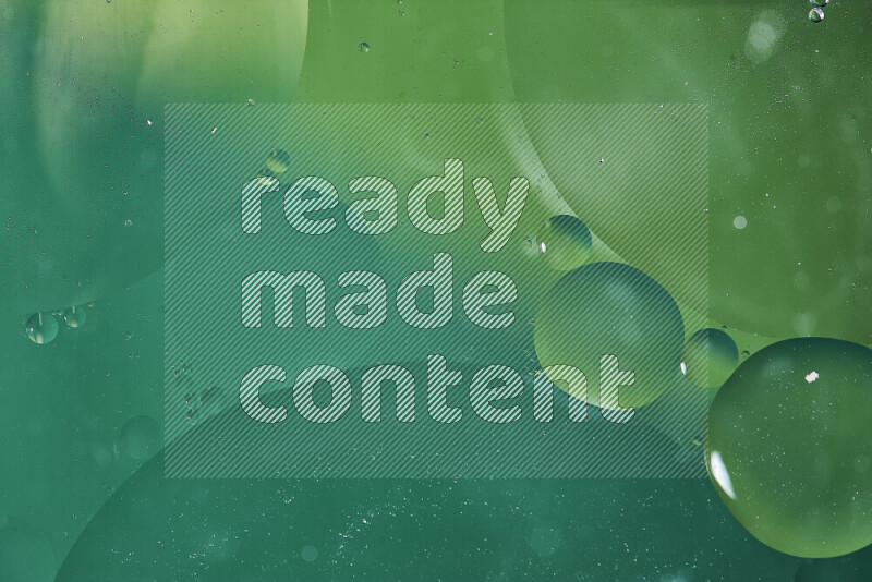 Close-ups of abstract oil bubbles on water surface in shades of green