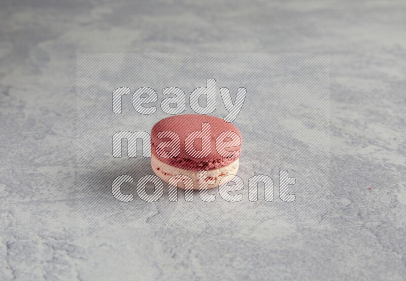 45º Shot of Pink Litchi Raspberry macaron on white  marble background