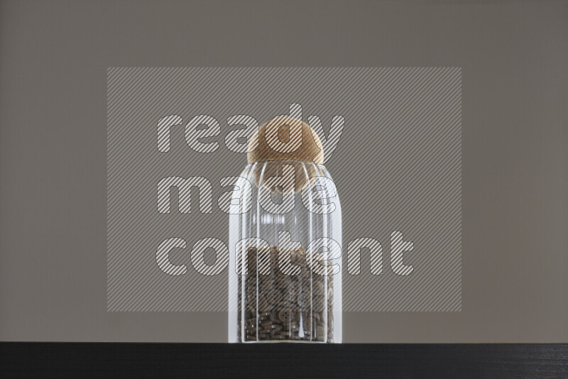 Buttons in a glass jar on black background