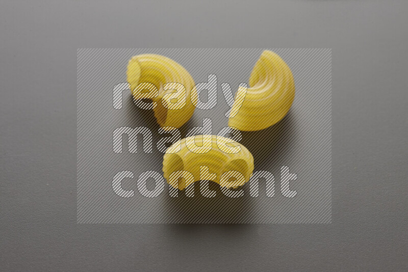 Elbow pasta on grey background