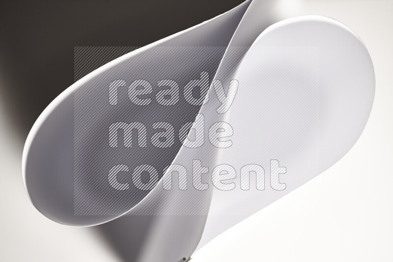 An abstract art of paper folded into smooth curves in grey gradients